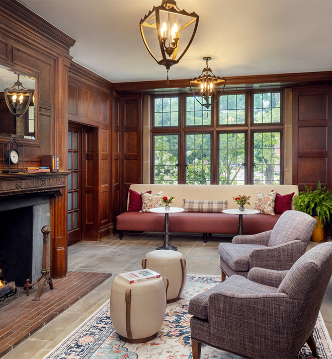 a room with a fireplace and chairs