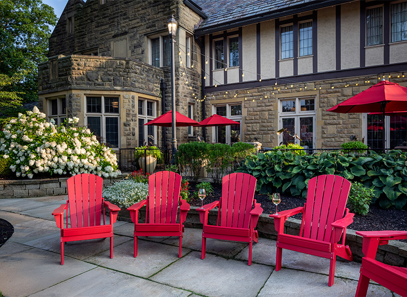 red chairs and umbrellas in front of a building