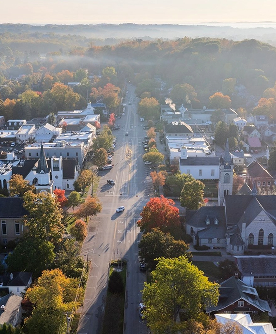 a road with cars and trees in the background
