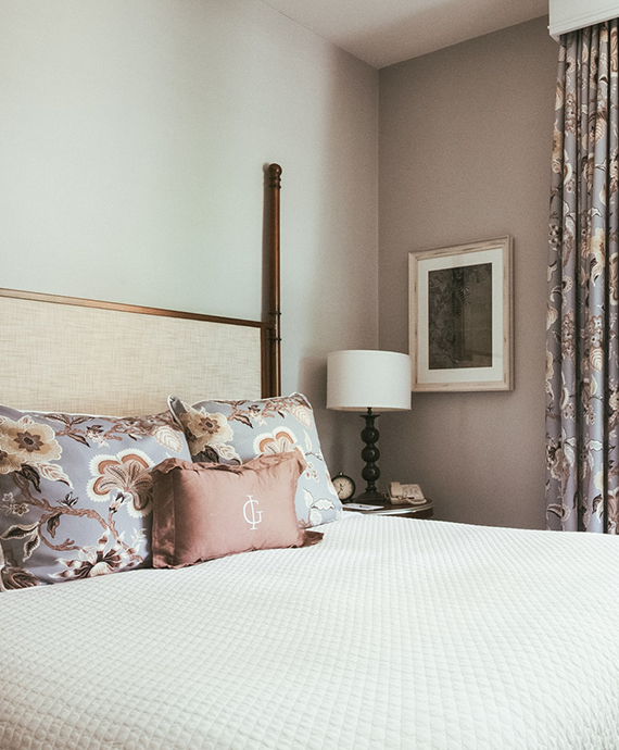 a bed with a lamp and pillows