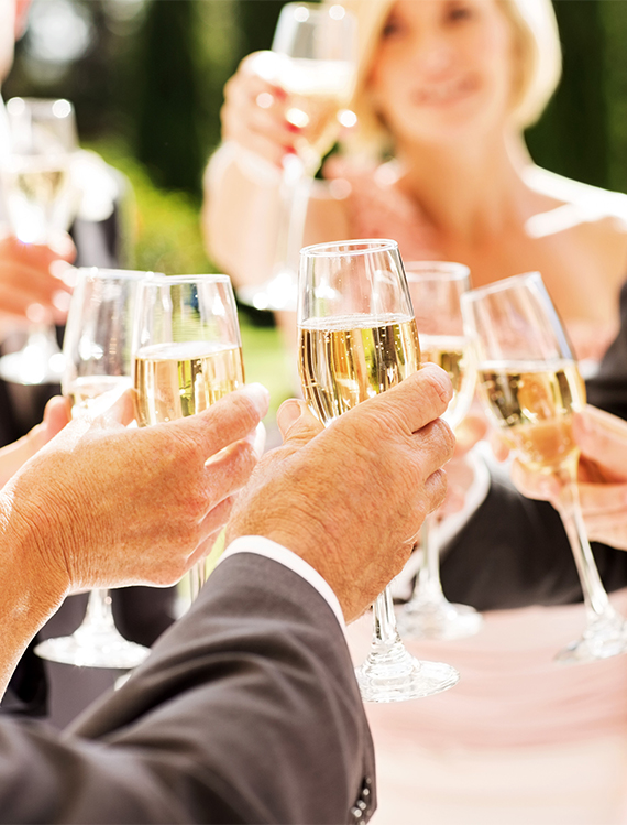 a group of people holding glasses of champagne