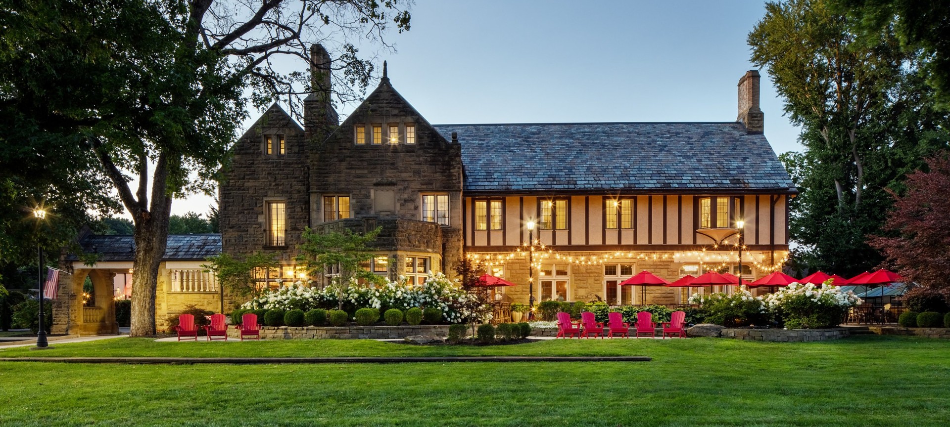 a large house with lawn and chairs