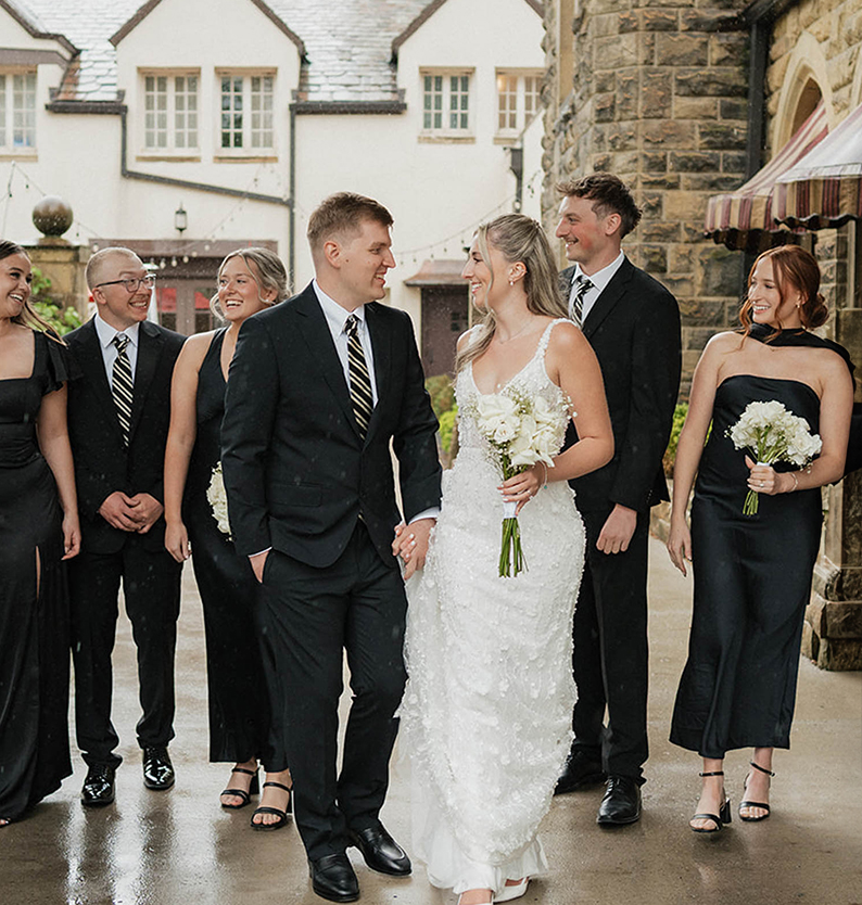 a man and woman walking down a sidewalk with other people