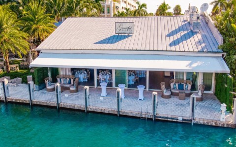 a building with tables and chairs on a dock