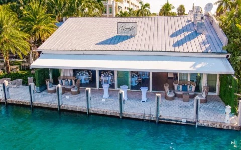 a building with tables and chairs on a dock