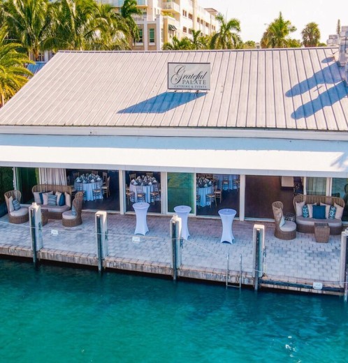 a building with tables and chairs on a dock