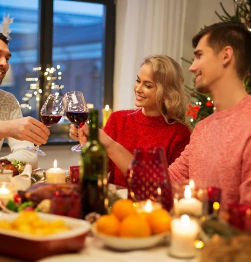 a group of people sitting around a table with wine glasses