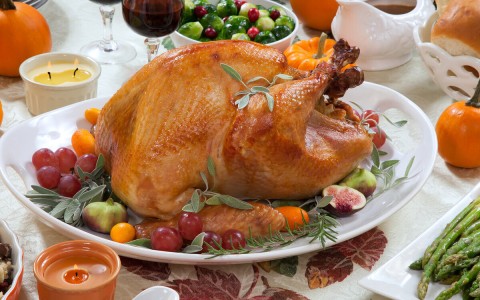 a turkey on a plate with fruit and vegetables