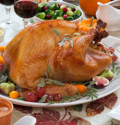 a turkey on a plate with fruit and vegetables