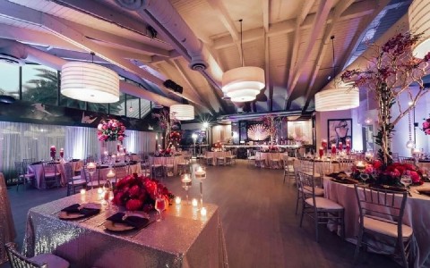 a room with tables and chairs and flowers