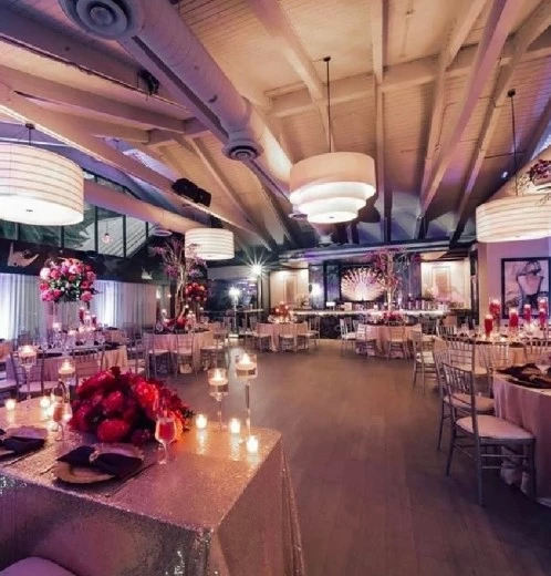 a room with tables and chairs and flowers