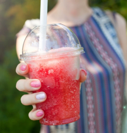 Woman holding a red slushy 