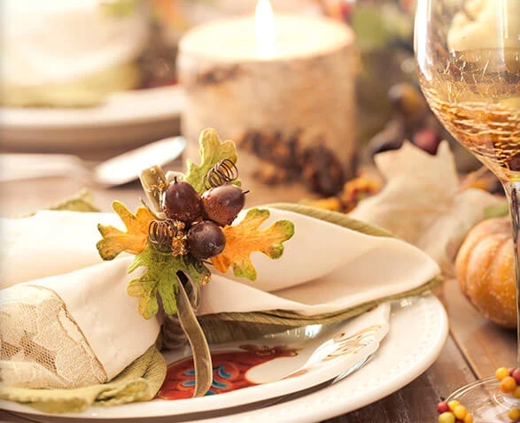 a table with a candle and a napkin