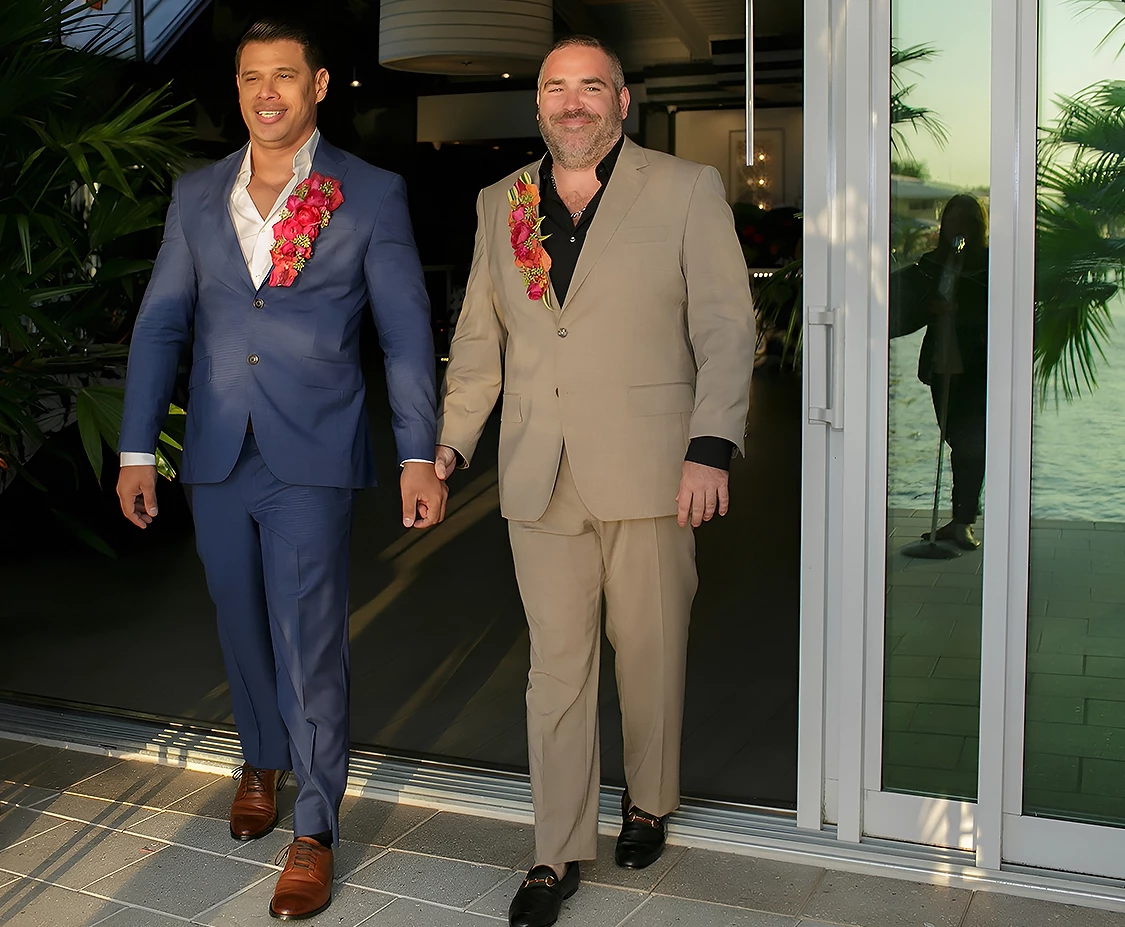 two men in suits walking by a glass door