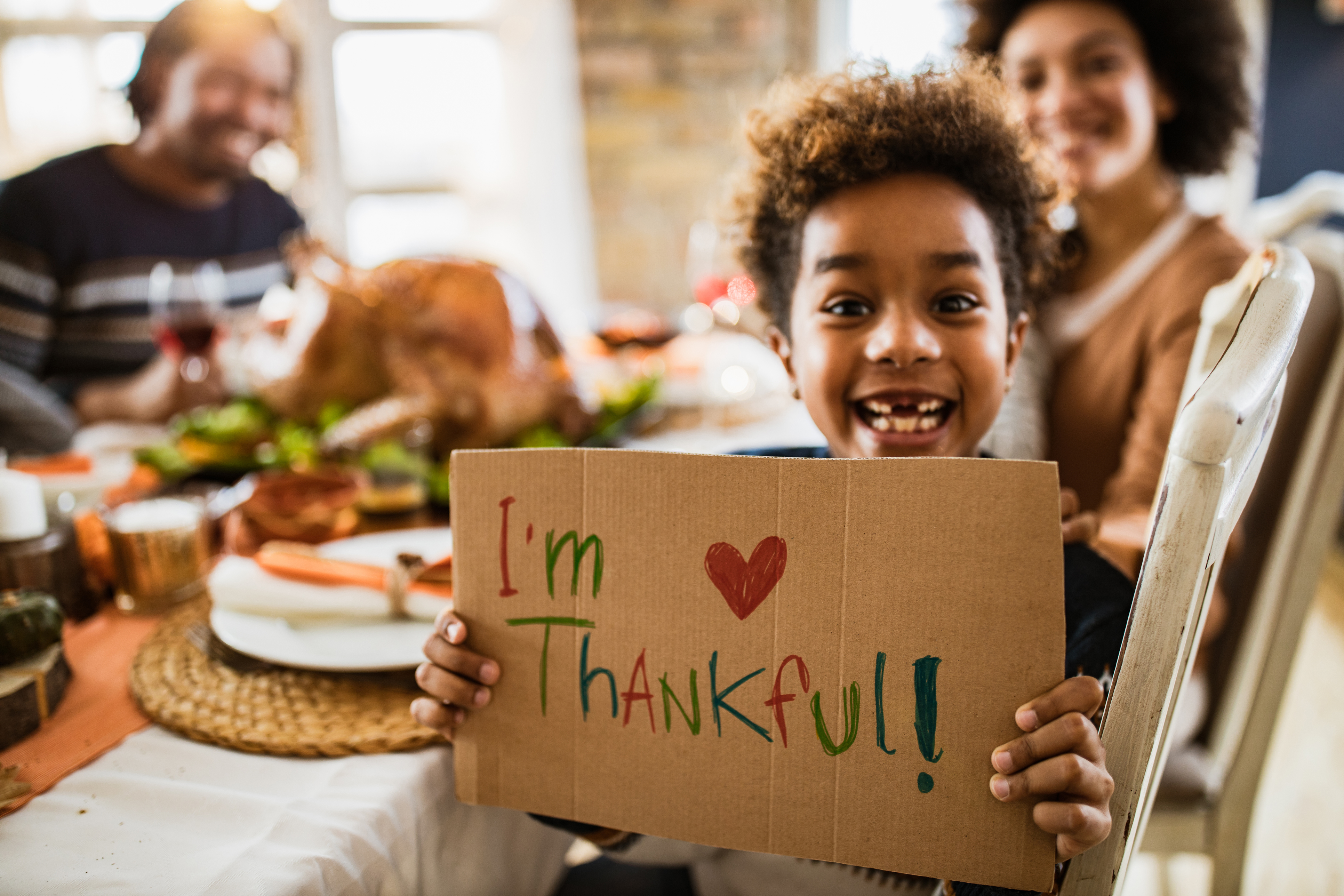 kid with Im thankful sign