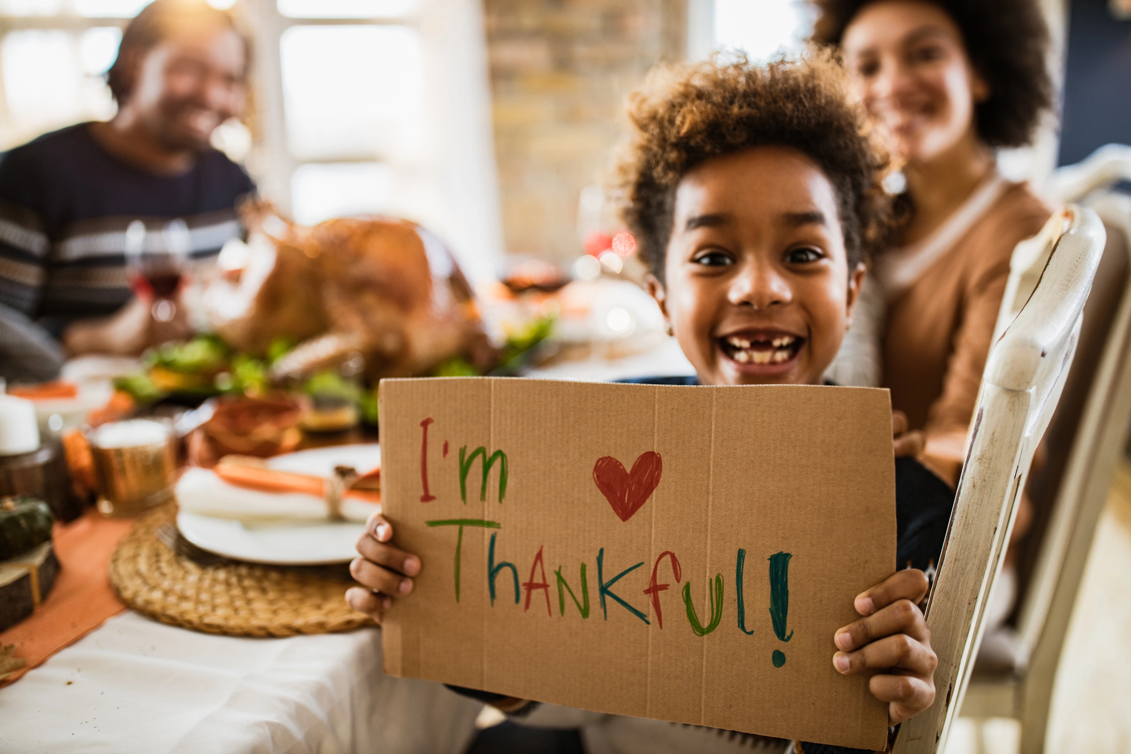 kid with Im thankful sign