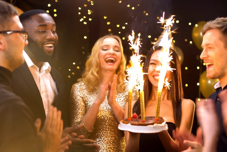 group of friends with birthday cake