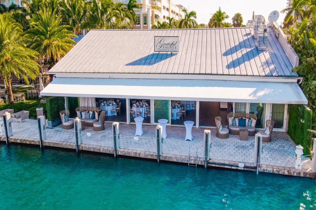 a building with tables and chairs on a dock