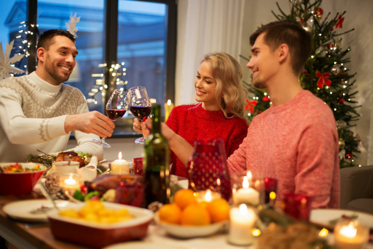 a group of people sitting around a table with wine glasses