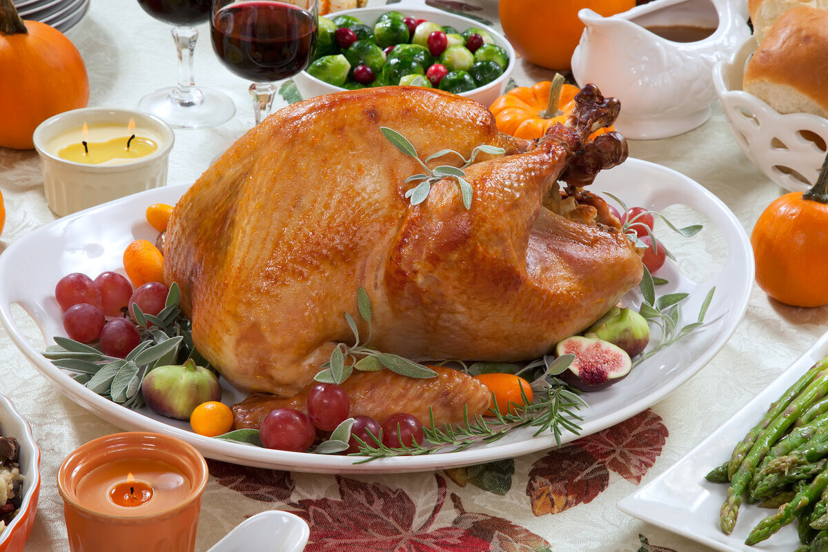 a turkey on a plate with fruit and vegetables