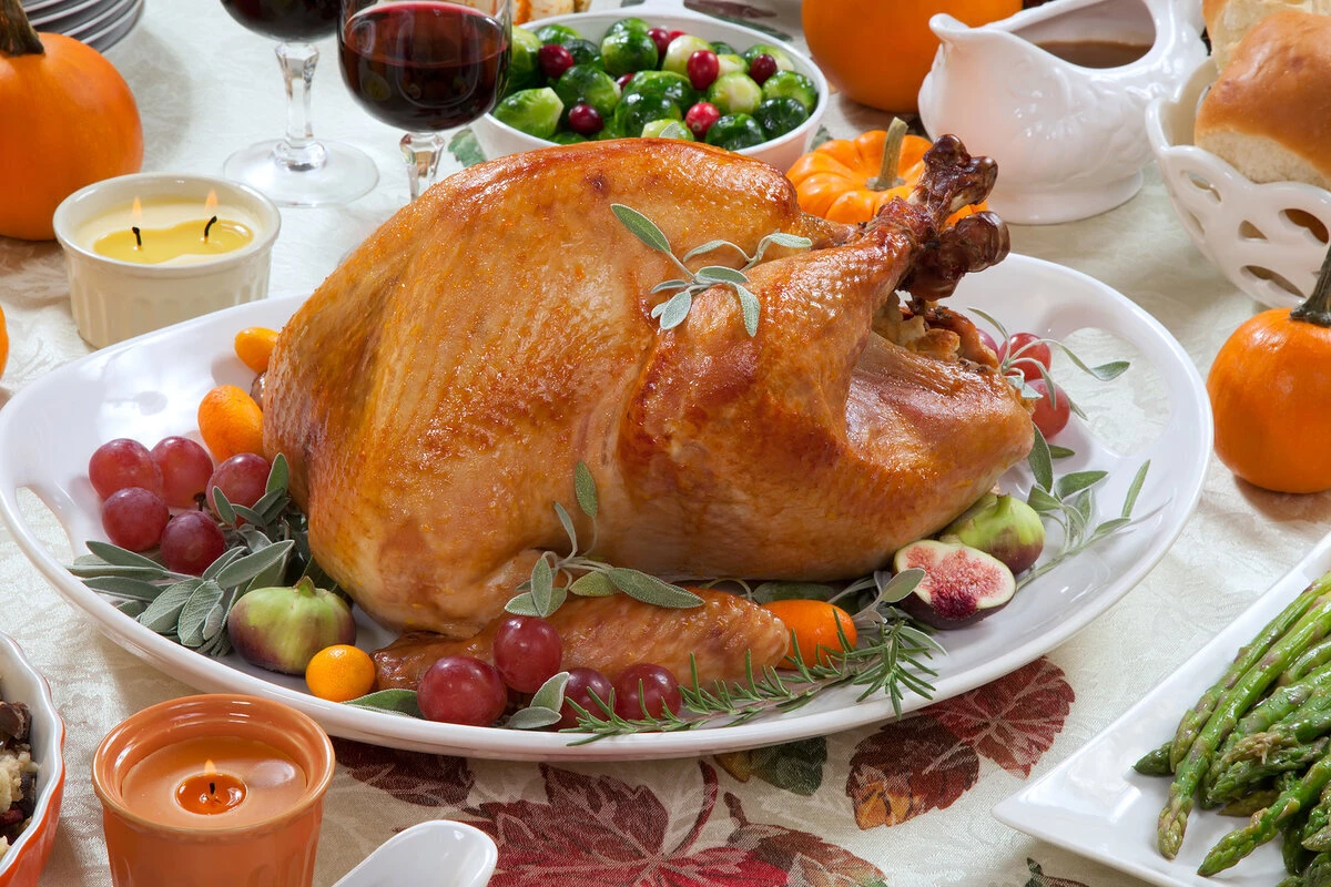 a turkey on a plate with fruit and vegetables