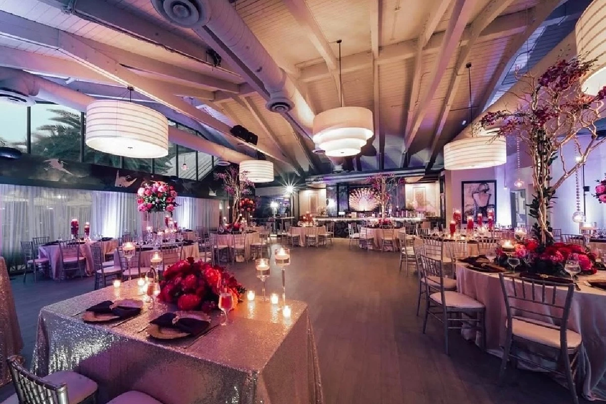 a room with tables and chairs and flowers