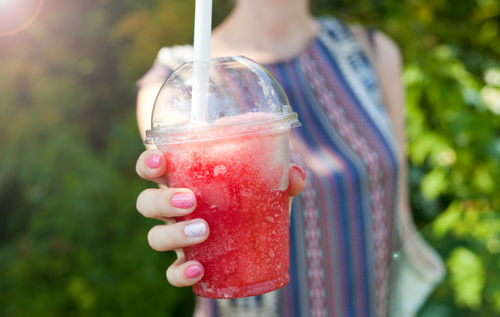 Woman holding a red slushy