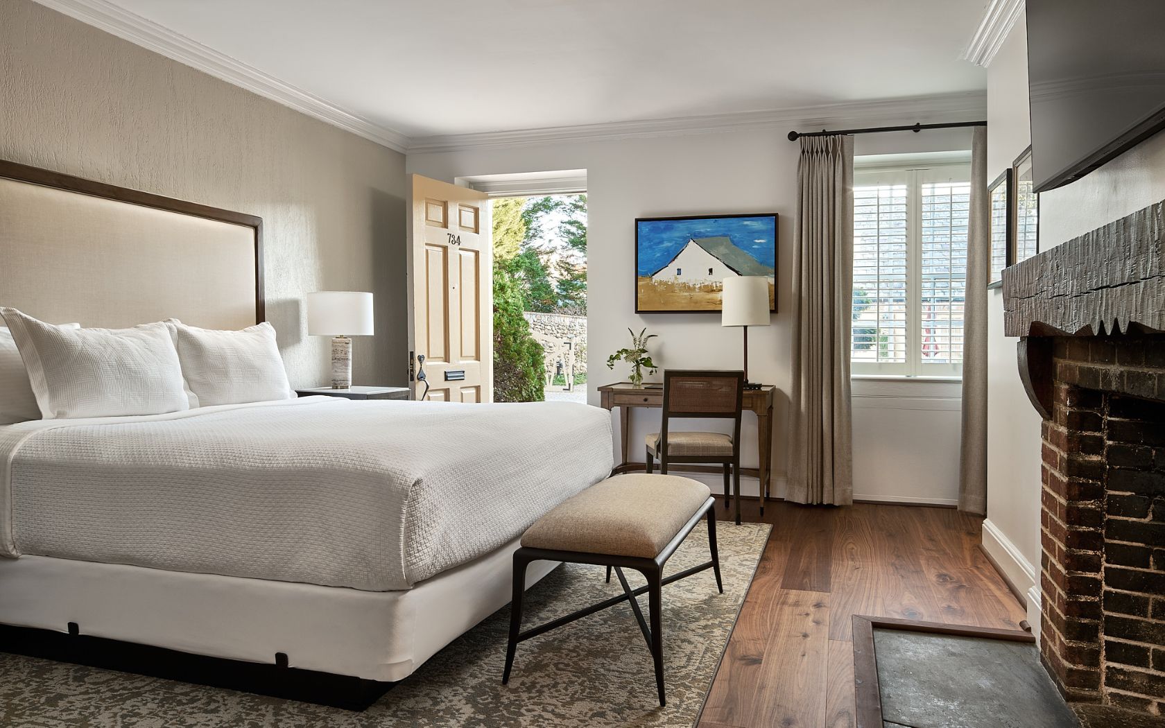 a bedroom with a bed and a fireplace