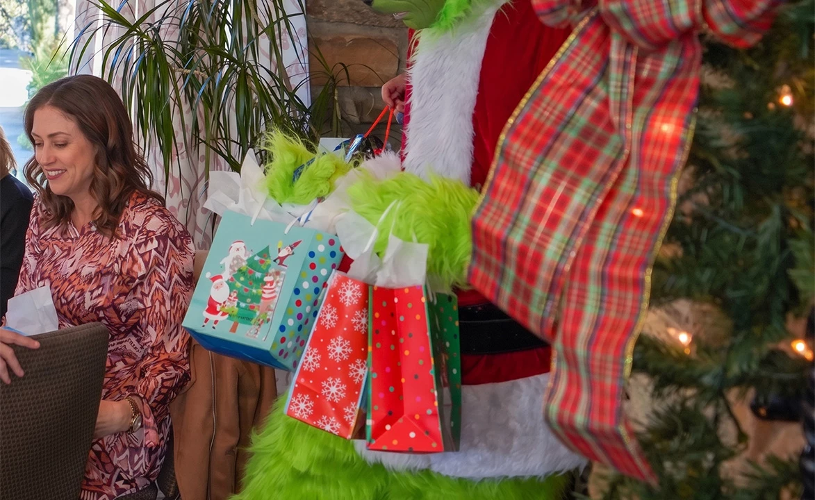 a person in a garment holding presents