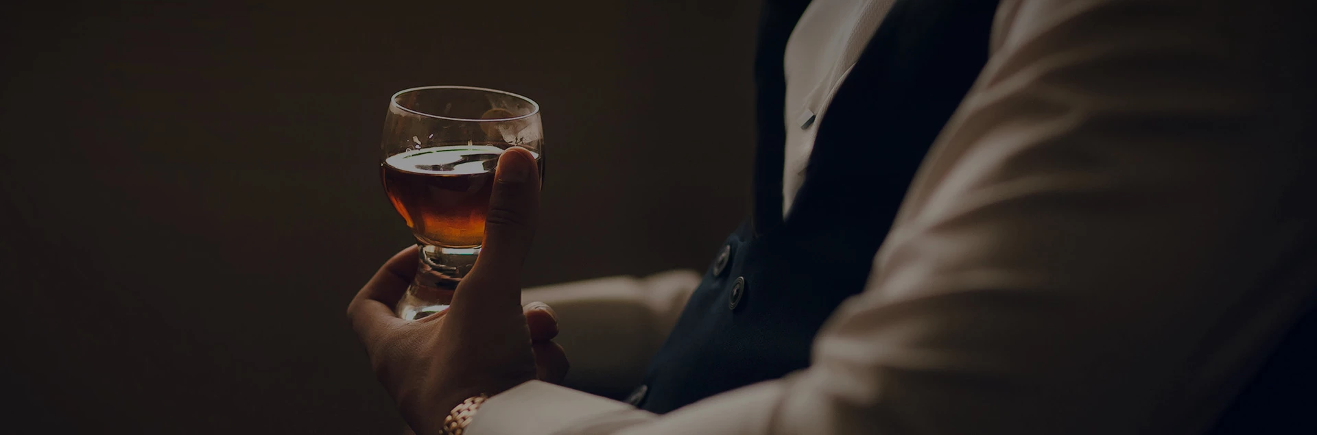 a man holding a whiskey glass