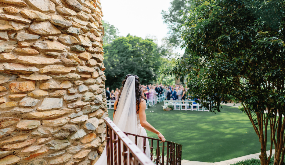a woman in a white dress walking down a staircase