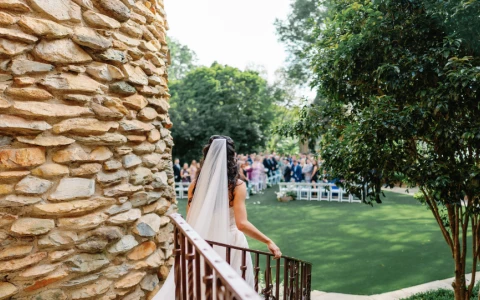 a woman in a white dress walking down a staircase