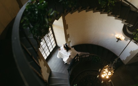 a woman in a white dress on a spiral staircase