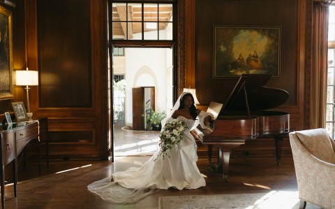 a woman in a wedding dress holding a bouquet of flowers