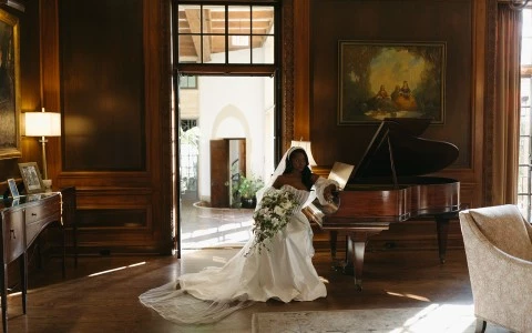 a woman in a wedding dress holding a bouquet of flowers