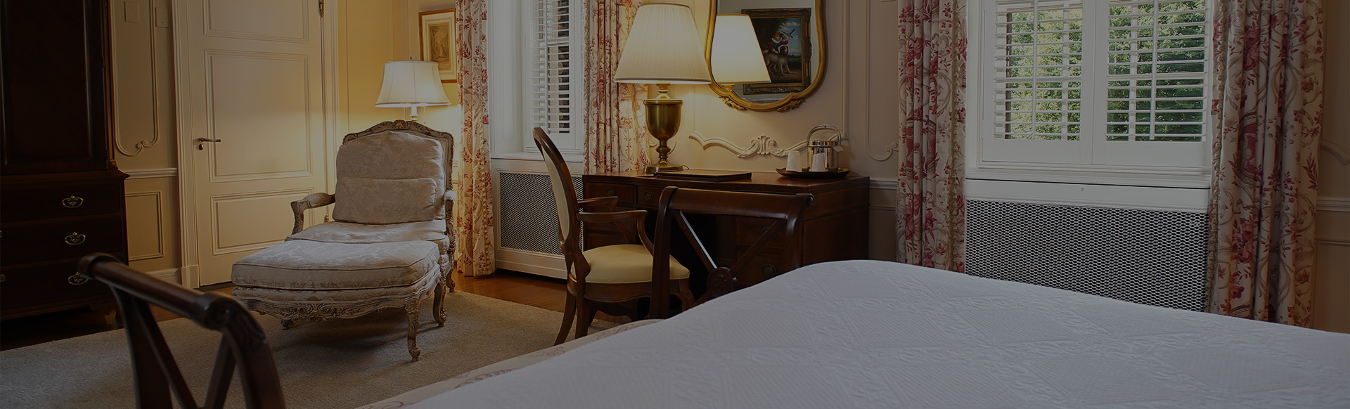 a bedroom with a desk and chair