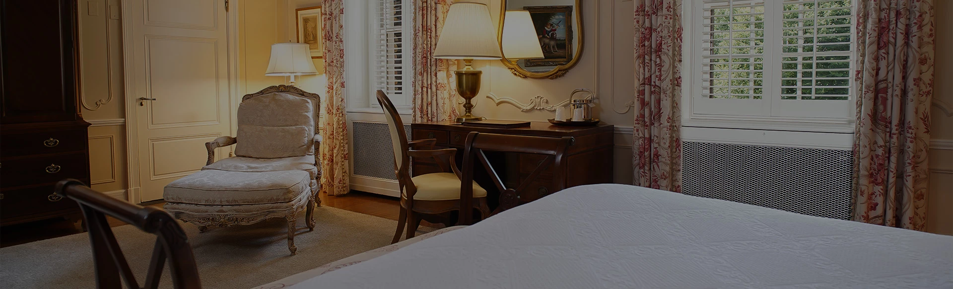 a bedroom with a desk and chair