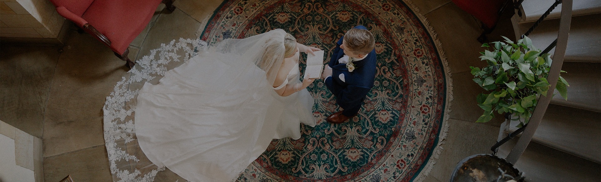 a bride and groom looking at a book