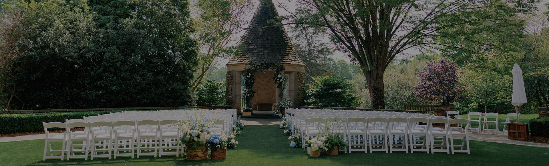 a wedding venue with chairs and flowers