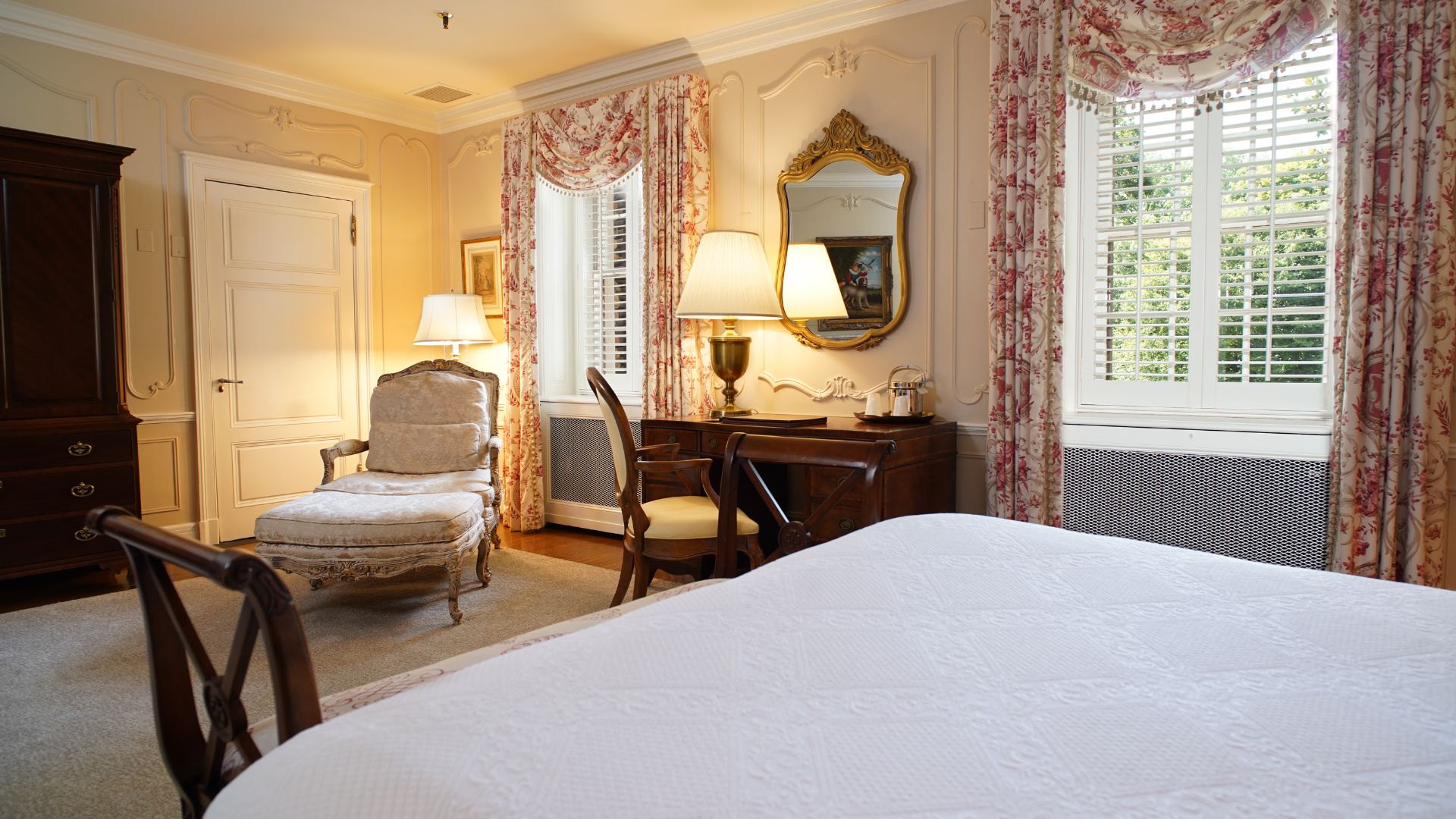 a bedroom with a bed and a chair