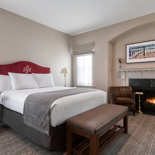 clean bedroom with a fireplace and brown seating