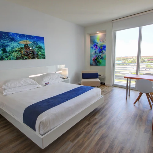 spacious bedroom with artistic decor on the walls