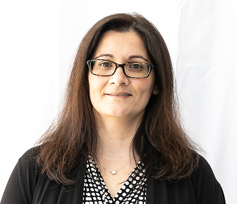 a woman with long brown hair wearing glasses