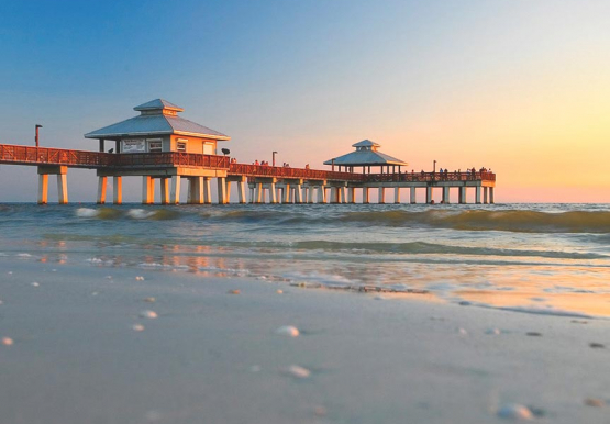 Red beach pier on ocean shore 
