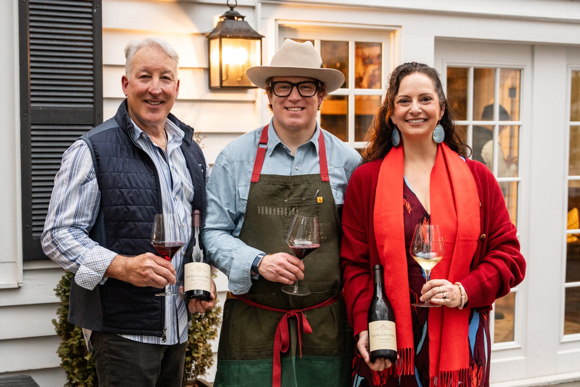 a group of people holding wine glasses