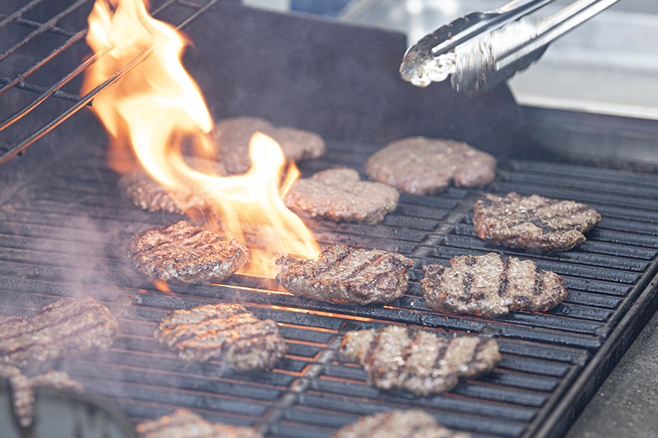 a burgers cooking on a grill