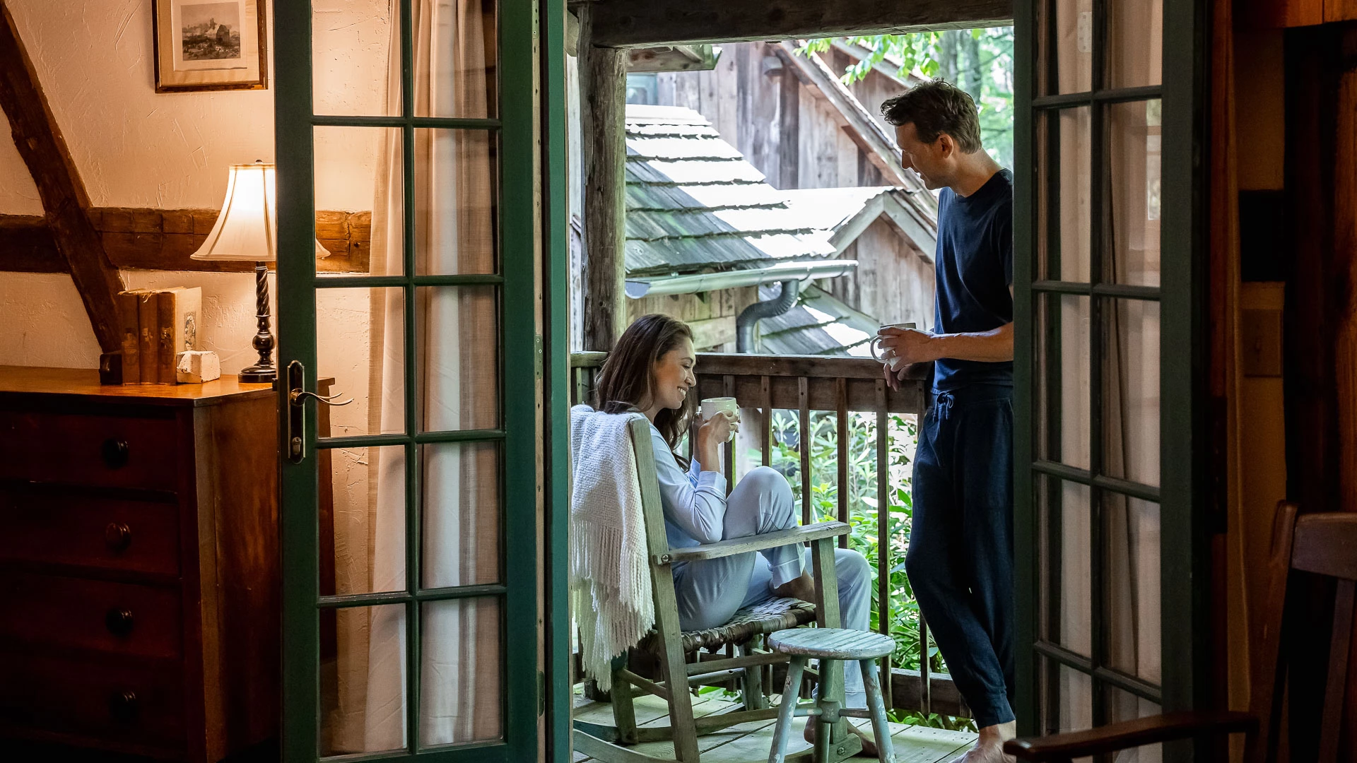 a man and woman sitting on a chair on a porch