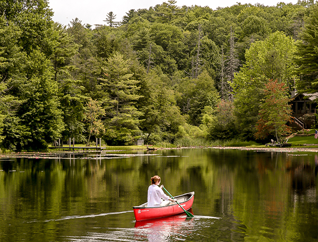 a woman in a canoe on a lake