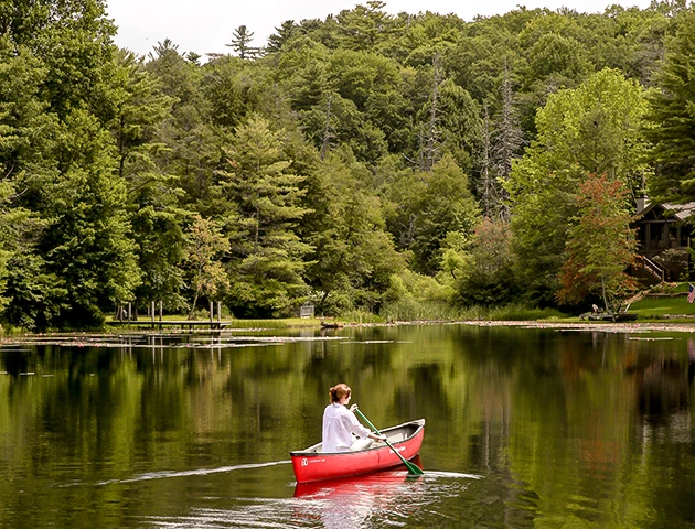 a woman in a canoe on a lake