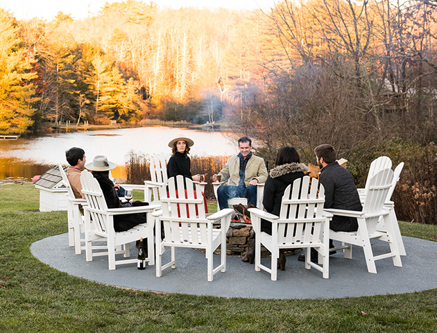 a group of people sitting around a fire pit